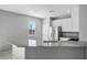 Bright kitchen with stainless steel appliances, light countertops, and bar stool seating at 7990 Formitch Ct, Las Vegas, NV 89166