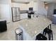 Open kitchen featuring granite countertops, stainless steel appliances, and a breakfast bar at 7990 Formitch Ct, Las Vegas, NV 89166