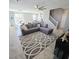 Comfortable living room featuring tile flooring, a ceiling fan, and a gray sectional sofa at 7990 Formitch Ct, Las Vegas, NV 89166