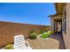 Private backyard with gravel, brick accents, desert landscaping, and seating at 800 Rosewater Dr, Henderson, NV 89011