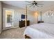 Bright bedroom with a four-poster bed, a TV, and access to the outside at 800 Rosewater Dr, Henderson, NV 89011