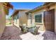 Charming patio with brick flooring, outdoor dining set, and flower accents at 800 Rosewater Dr, Henderson, NV 89011