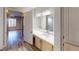 Well-lit bathroom vanity area with bright white countertop and warm wood cabinets at 8070 W Russell Rd # 1046, Las Vegas, NV 89113