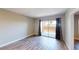Unfurnished bedroom with wood flooring and sliding glass doors to a private patio area at 8070 W Russell Rd # 1046, Las Vegas, NV 89113
