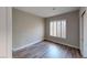 This bedroom offers a clean and airy space with modern flooring and a window for natural light at 8070 W Russell Rd # 1046, Las Vegas, NV 89113