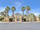 Exterior shot of a single-story clubhouse with a beige facade and several palm trees in the foreground at 8070 W Russell Rd # 1046, Las Vegas, NV 89113