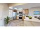 Modern kitchen with stainless steel appliances, light wood cabinets, and a breakfast bar with marble countertops at 8070 W Russell Rd # 1046, Las Vegas, NV 89113