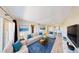 Bright living room featuring stylish furniture, blue accent pillows, and sleek decor creating an inviting space at 8070 W Russell Rd # 1046, Las Vegas, NV 89113