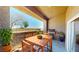 Enjoy outdoor dining on this covered patio with a wooden table, grill, and lush potted plants at 8070 W Russell Rd # 1046, Las Vegas, NV 89113