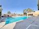Community pool surrounded by lounging chairs, trees, and a covered area at 8070 W Russell Rd # 1046, Las Vegas, NV 89113