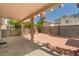 Spacious covered patio with brick pavers, concrete, mature landscaping, and a basketball hoop at 8509 W Rochelle Ave, Las Vegas, NV 89147