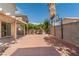 Wide view of the backyard featuring pavers, mature landscaping, and block wall fencing at 8509 W Rochelle Ave, Las Vegas, NV 89147