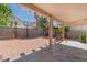 Spacious backyard with brick pavers, concrete, mature landscaping, and a basketball hoop at 8509 W Rochelle Ave, Las Vegas, NV 89147