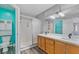 Bathroom featuring a double sink, modern lighting, glass enclosed shower, and a toilet room at 8509 W Rochelle Ave, Las Vegas, NV 89147