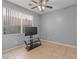 Neutral bedroom with modern ceiling fan, large window, and tile flooring for a comfortable living space at 8509 W Rochelle Ave, Las Vegas, NV 89147