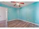 Bright bedroom with wood-look flooring, a ceiling fan, and a view to another room at 8509 W Rochelle Ave, Las Vegas, NV 89147