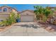 Home exterior featuring a two-car garage, well-maintained lawn, and lovely curb appeal at 8509 W Rochelle Ave, Las Vegas, NV 89147