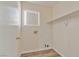 Functional laundry room with modern flooring, shelving, and essential appliance connections at 8509 W Rochelle Ave, Las Vegas, NV 89147