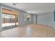 Spacious living area with sliding glass doors to the backyard, showcasing tile flooring at 8509 W Rochelle Ave, Las Vegas, NV 89147