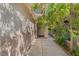 Covered walkway and entry, accented with stucco walls and desert landscaping at 8509 W Rochelle Ave, Las Vegas, NV 89147