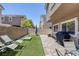 Backyard featuring artifical grass, patio with brick and seating area with grill at 8639 Horizon Wind Ave # 102, Las Vegas, NV 89178