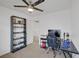 Bedroom featuring a ceiling fan, built-in shelves and black computer desk and chair at 8639 Horizon Wind Ave # 102, Las Vegas, NV 89178