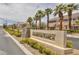 Arlington Ranch entrance featuring a stone accented sign, mature palm trees, and well-maintained landscaping at 8639 Horizon Wind Ave # 102, Las Vegas, NV 89178