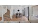 The bright dining room features a staircase, a dining table with seating for four, and a sliding door at 8639 Horizon Wind Ave # 102, Las Vegas, NV 89178