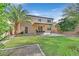 Large backyard with a covered patio, mature trees and lush green grass at 9044 Blue Raven Ave # R, Las Vegas, NV 89143