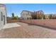 View of a backyard featuring desert landscaping, brick wall, and a small patio at 9644 Flying Eagle Ln, Las Vegas, NV 89123