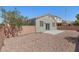 Backyard showcasing desert landscaping, brick wall, and a small patio at 9644 Flying Eagle Ln, Las Vegas, NV 89123