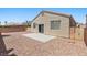 Property backyard featuring desert landscaping, brick wall, and concrete patio at 9644 Flying Eagle Ln, Las Vegas, NV 89123