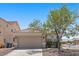 Charming single-story home features a two-car garage and a mature tree in the front yard at 9644 Flying Eagle Ln, Las Vegas, NV 89123