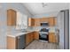 Modern kitchen featuring oak cabinets, updated stainless steel appliances at 9644 Flying Eagle Ln, Las Vegas, NV 89123