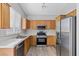 Bright kitchen features stainless steel appliances, wood cabinets, and durable countertops at 9644 Flying Eagle Ln, Las Vegas, NV 89123