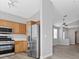 Modern kitchen with stainless steel appliances, wood cabinets, and gray walls at 9644 Flying Eagle Ln, Las Vegas, NV 89123