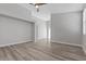 Spacious living room features modern gray walls, wood-look floors, and a large archway at 9644 Flying Eagle Ln, Las Vegas, NV 89123