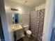Functional bathroom featuring a pedestal sink, toilet, and shower with patterned curtain at , Las Vegas, NV 89119