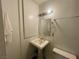 Cozy bathroom with a pedestal sink, tiled mirror and essential fixtures in clean design at , Las Vegas, NV 89119
