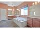 This bathroom features a soaking tub, dual vanities, and a large window at , Las Vegas, NV 89131