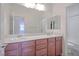 Bright bathroom with double sinks, large mirror, and a separate toilet area at , Las Vegas, NV 89131