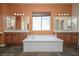 Luxurious bathroom with double vanities, a soaking tub, and modern fixtures at , Las Vegas, NV 89131