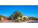 Attractive single-story home showcasing desert landscaping, a large tree, and a brick driveway at , Las Vegas, NV 89131