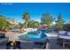 Backyard pool with waterfall feature, surrounded by lounge furniture and tropical plants at , Las Vegas, NV 89131