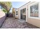 Backyard featuring stone pavers, block wall, and a sliding glass door at 1012 Collingtree St, Las Vegas, NV 89145