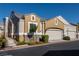 View of the home with a two-car garage, neutral color palette, and manicured shrubbery at 1012 Collingtree St, Las Vegas, NV 89145