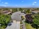 Stunning aerial view showcases a beautiful desert home with lush landscaping and mountain views in the distance at 1016 Sable Mist Ct, Las Vegas, NV 89144