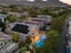 Features a backyard pool, desert landscaping, and houses with solar panels against a mountain backdrop at 1016 Sable Mist Ct, Las Vegas, NV 89144