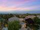 Sweeping aerial view of a single-story desert home with mature landscaping in a residential neighborhood at dusk at 1016 Sable Mist Ct, Las Vegas, NV 89144