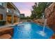 A luxurious backyard oasis with a pool, waterfall, and manicured landscaping at 1016 Sable Mist Ct, Las Vegas, NV 89144